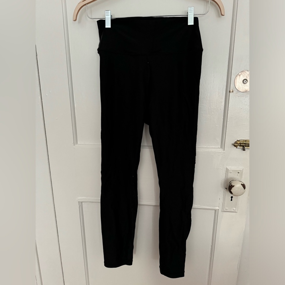 We Wore What black activewear leggings with satin finish. Size medium.